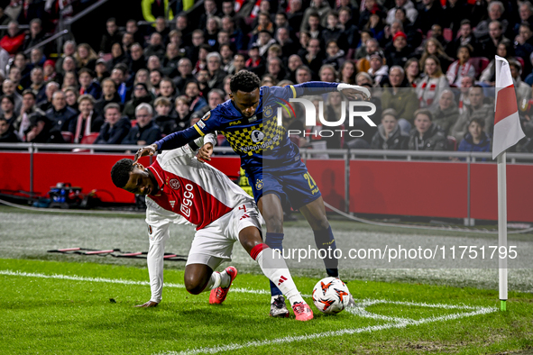 AFC Ajax Amsterdam defender Jorrel Hato and Maccabi Tel Aviv midfielder Issouf Sissokho play during the match between Ajax and Maccabi Tel A...