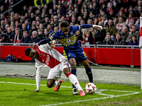 AFC Ajax Amsterdam defender Jorrel Hato and Maccabi Tel Aviv midfielder Issouf Sissokho play during the match between Ajax and Maccabi Tel A...