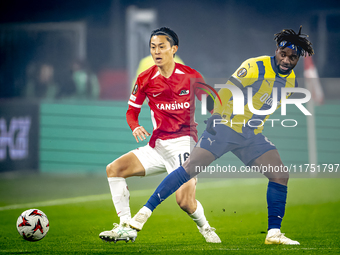 AZ Alkmaar defender Seiya Maikuma and Fenerbahce forward Allan Saint-Maximin play during the match between AZ and Fenerbahce at the AFAS Sta...