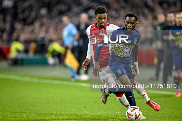 AFC Ajax Amsterdam defender Jorrel Hato and Maccabi Tel Aviv midfielder Issouf Sissokho play during the match between Ajax and Maccabi Tel A...