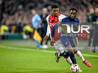 AFC Ajax Amsterdam defender Jorrel Hato and Maccabi Tel Aviv midfielder Issouf Sissokho play during the match between Ajax and Maccabi Tel A...