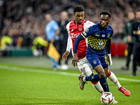 AFC Ajax Amsterdam defender Jorrel Hato and Maccabi Tel Aviv midfielder Issouf Sissokho play during the match between Ajax and Maccabi Tel A...