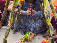 Hindu devotees perform rituals and offer prayers at sunset on the banks of the River Sabarmati during the Chhath Puja festival in Ahmedabad,...