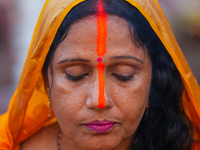 Hindu devotees perform rituals and offer prayers at sunset on the banks of the River Sabarmati during the Chhath Puja festival in Ahmedabad,...