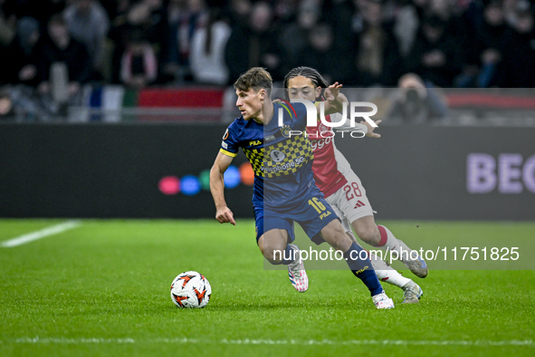 Maccabi Tel Aviv midfielder Gavriel Kanichowsky and AFC Ajax Amsterdam midfielder Kian Fitz-Jim play during the match between Ajax and Macca...