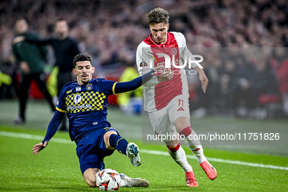 Maccabi Tel Aviv forward Dor Turgeman and AFC Ajax Amsterdam forward Mika Godts play during the match between Ajax and Maccabi Tel Aviv at t...