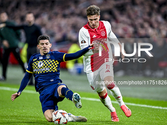 Maccabi Tel Aviv forward Dor Turgeman and AFC Ajax Amsterdam forward Mika Godts play during the match between Ajax and Maccabi Tel Aviv at t...