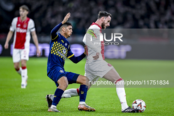 Maccabi Tel Aviv midfielder Elad Madmon and AFC Ajax Amsterdam midfielder Branco van den Boomen play during the match between Ajax and Macca...