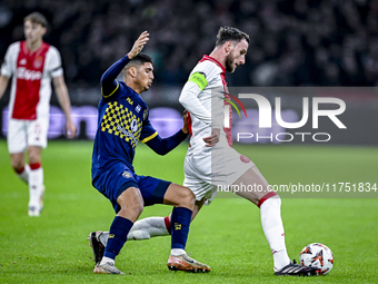 Maccabi Tel Aviv midfielder Elad Madmon and AFC Ajax Amsterdam midfielder Branco van den Boomen play during the match between Ajax and Macca...