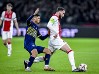 Maccabi Tel Aviv midfielder Elad Madmon and AFC Ajax Amsterdam midfielder Branco van den Boomen play during the match between Ajax and Macca...