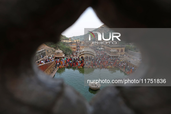 Hindu devotees perform rituals of the 'Chhath Puja' festival at the Shrine Galta Ji temple Kund in Jaipur, Rajasthan, India, on November 7,...