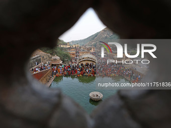 Hindu devotees perform rituals of the 'Chhath Puja' festival at the Shrine Galta Ji temple Kund in Jaipur, Rajasthan, India, on November 7,...