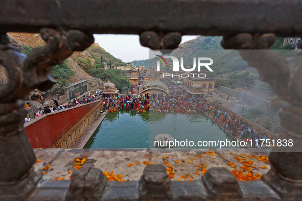 Hindu devotees perform rituals of the 'Chhath Puja' festival at the Shrine Galta Ji temple Kund in Jaipur, Rajasthan, India, on November 7,...