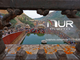 Hindu devotees perform rituals of the 'Chhath Puja' festival at the Shrine Galta Ji temple Kund in Jaipur, Rajasthan, India, on November 7,...