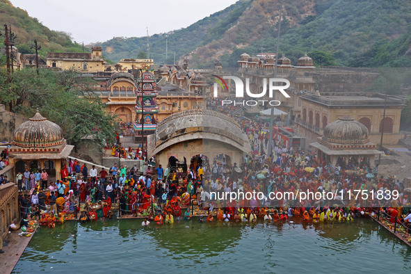 Hindu devotees perform rituals of the 'Chhath Puja' festival at the Shrine Galta Ji temple Kund in Jaipur, Rajasthan, India, on November 7,...