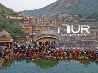 Hindu devotees perform rituals of the 'Chhath Puja' festival at the Shrine Galta Ji temple Kund in Jaipur, Rajasthan, India, on November 7,...