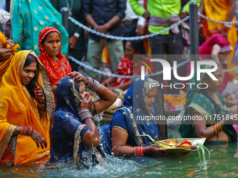 Hindu devotees perform rituals of the 'Chhath Puja' festival at the Shrine Galta Ji temple Kund in Jaipur, Rajasthan, India, on November 7,...