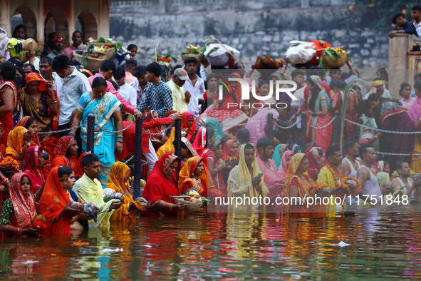 Hindu devotees perform rituals of the 'Chhath Puja' festival at the Shrine Galta Ji temple Kund in Jaipur, Rajasthan, India, on November 7,...