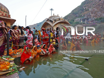 Hindu devotees perform rituals of the 'Chhath Puja' festival at the Shrine Galta Ji temple Kund in Jaipur, Rajasthan, India, on November 7,...