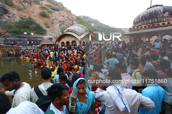 Hindu devotees perform rituals of the 'Chhath Puja' festival at the Shrine Galta Ji temple Kund in Jaipur, Rajasthan, India, on November 7,...