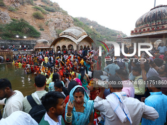 Hindu devotees perform rituals of the 'Chhath Puja' festival at the Shrine Galta Ji temple Kund in Jaipur, Rajasthan, India, on November 7,...