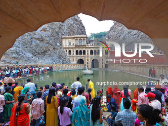 Hindu devotees perform rituals of the 'Chhath Puja' festival at the Shrine Galta Ji temple Kund in Jaipur, Rajasthan, India, on November 7,...