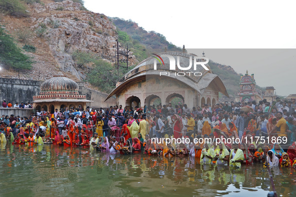 Hindu devotees perform rituals of the 'Chhath Puja' festival at the Shrine Galta Ji temple Kund in Jaipur, Rajasthan, India, on November 7,...