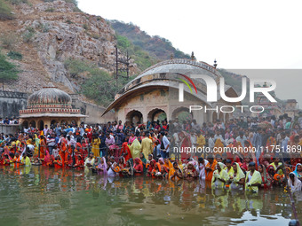 Hindu devotees perform rituals of the 'Chhath Puja' festival at the Shrine Galta Ji temple Kund in Jaipur, Rajasthan, India, on November 7,...