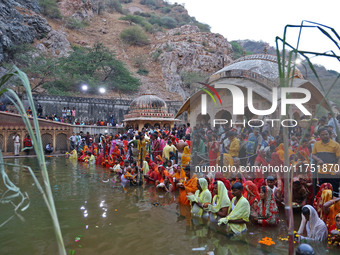 Hindu devotees perform rituals of the 'Chhath Puja' festival at the Shrine Galta Ji temple Kund in Jaipur, Rajasthan, India, on November 7,...