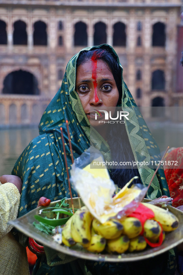 A Hindu devotee performs rituals of the 'Chhath Puja' festival at the Shrine Galta Ji temple Kund in Jaipur, Rajasthan, India, on November 7...