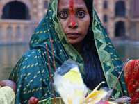 A Hindu devotee performs rituals of the 'Chhath Puja' festival at the Shrine Galta Ji temple Kund in Jaipur, Rajasthan, India, on November 7...