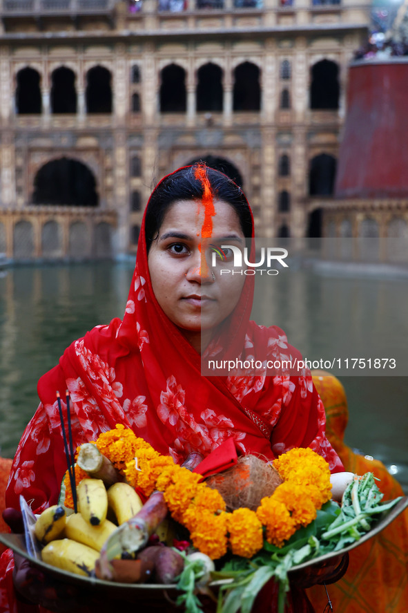 A Hindu devotee performs rituals of the 'Chhath Puja' festival at the Shrine Galta Ji temple Kund in Jaipur, Rajasthan, India, on November 7...