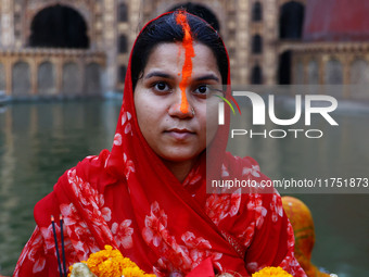 A Hindu devotee performs rituals of the 'Chhath Puja' festival at the Shrine Galta Ji temple Kund in Jaipur, Rajasthan, India, on November 7...