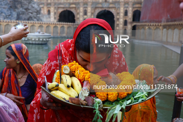 A Hindu devotee performs rituals of the 'Chhath Puja' festival at the Shrine Galta Ji temple Kund in Jaipur, Rajasthan, India, on November 7...