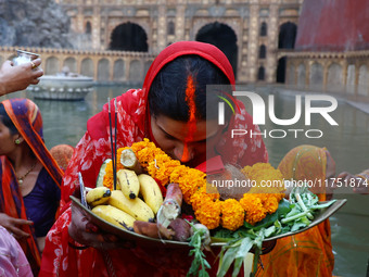 A Hindu devotee performs rituals of the 'Chhath Puja' festival at the Shrine Galta Ji temple Kund in Jaipur, Rajasthan, India, on November 7...