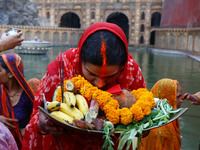 A Hindu devotee performs rituals of the 'Chhath Puja' festival at the Shrine Galta Ji temple Kund in Jaipur, Rajasthan, India, on November 7...