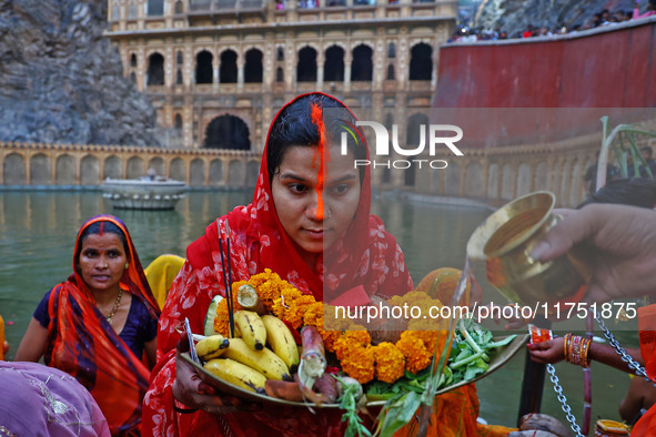 A Hindu devotee performs rituals of the 'Chhath Puja' festival at the Shrine Galta Ji temple Kund in Jaipur, Rajasthan, India, on November 7...