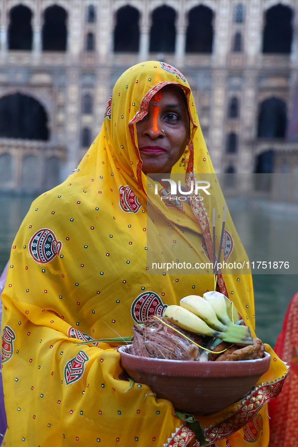 A Hindu devotee performs rituals of the 'Chhath Puja' festival at the Shrine Galta Ji temple Kund in Jaipur, Rajasthan, India, on November 7...