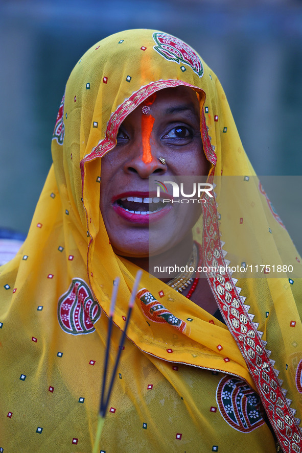 A Hindu devotee performs rituals of the 'Chhath Puja' festival at the Shrine Galta Ji temple Kund in Jaipur, Rajasthan, India, on November 7...