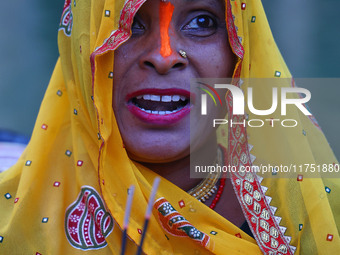 A Hindu devotee performs rituals of the 'Chhath Puja' festival at the Shrine Galta Ji temple Kund in Jaipur, Rajasthan, India, on November 7...