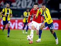 Fenerbahce defender Rodrigo Becao and AZ Alkmaar forward Troy Parrot play during the match between AZ and Fenerbahce at the AFAS Stadium for...