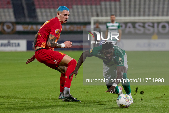 In Ta' Qali, Malta, on November 7, 2024, Franklin Sasere of Floriana moves away with the ball ahead of Alessandro Coppola of Birkirkara duri...