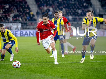 AZ Alkmaar defender Seiya Maikuma and Fenerbahce defender Caglar Soyuncu play during the match between AZ and Fenerbahce at the AFAS Stadium...