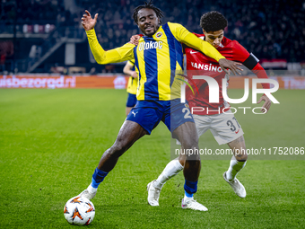 Fenerbahce forward Bright Osayi-Samuel and AZ Alkmaar defender Ro-Zangalo Daal play during the match AZ - Fenerbahce at the AFAS stadium for...