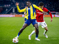 Fenerbahce forward Bright Osayi-Samuel and AZ Alkmaar defender Ro-Zangalo Daal play during the match AZ - Fenerbahce at the AFAS stadium for...