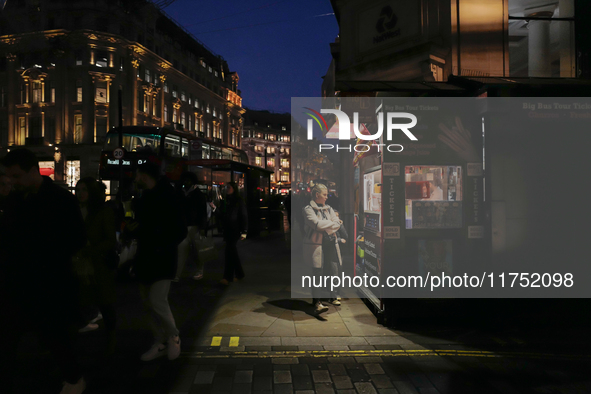 A woman looks at a kiosk in Regent Street, London, on November 5, 2024. 