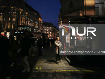 A woman looks at a kiosk in Regent Street, London, on November 5, 2024. (