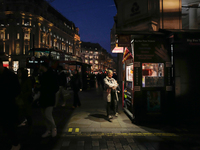 A woman looks at a kiosk in Regent Street, London, on November 5, 2024. (