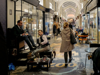 A shoe shiner works in the Burlington Arcade in London, England, on November 5, 2024. (