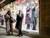 People stand outside a shop in Mayfair, London, on November 7, 2024. (